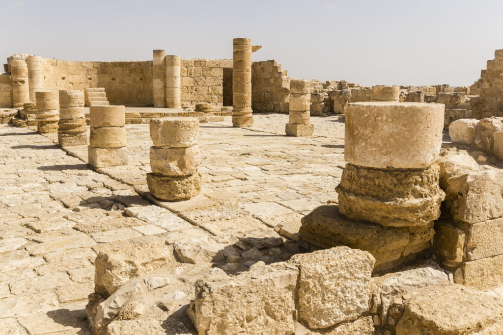 The crumbling ruins of Avdat, Isreal where columns stand half broken and the sandstone is weathered and damaged. and you can travel to the movie locations with Jaya Travel & Tours.