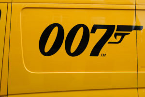 A close-up of the black 007 James Bond gun logo painted on the side of a yellow truck delivery panel van in Bordeaux , Aquitaine, France for Jaya Travel & Tours James Bond film locations.
