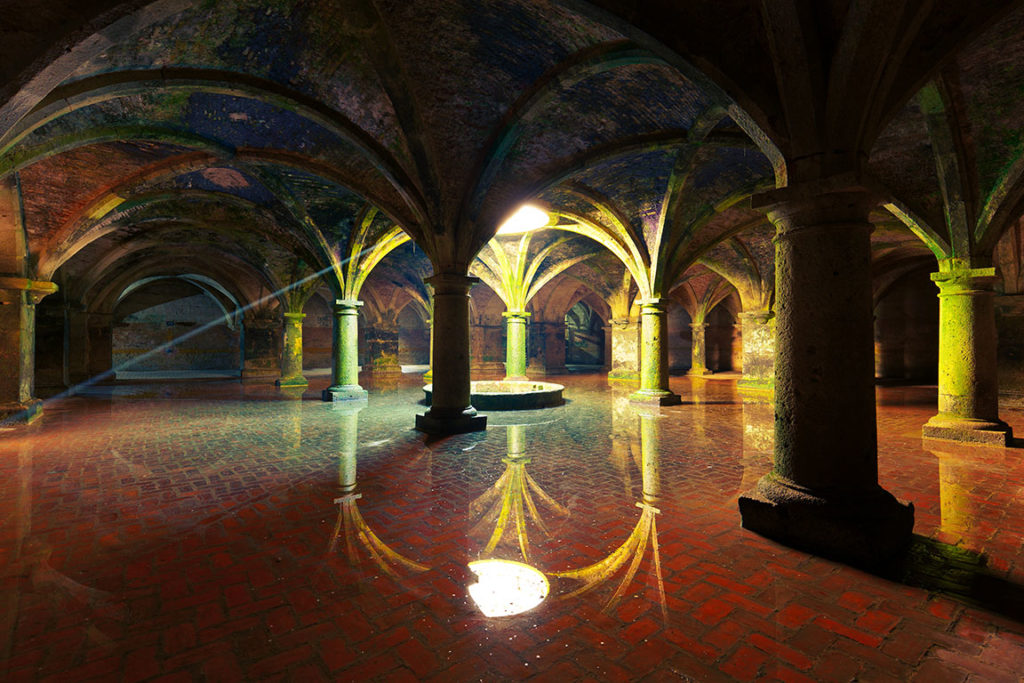 The light and ceiling reflects against the layer of water at the famous tourist attraction of the Portuguese Cistern of the Fortress of Mazagan in El-Jadida, Morocco during a tour by Jaya Travel & Tours.