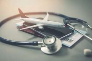 - Jaya Travel & Tours On a white table sits a pile of stacked passports, flight tickets, an airplane, and a stethoscope. The featured image in Jaya Travel & Tours blog, "6 Reasons to Get Travel Insurance," which describes why travelers should buy trip protection.