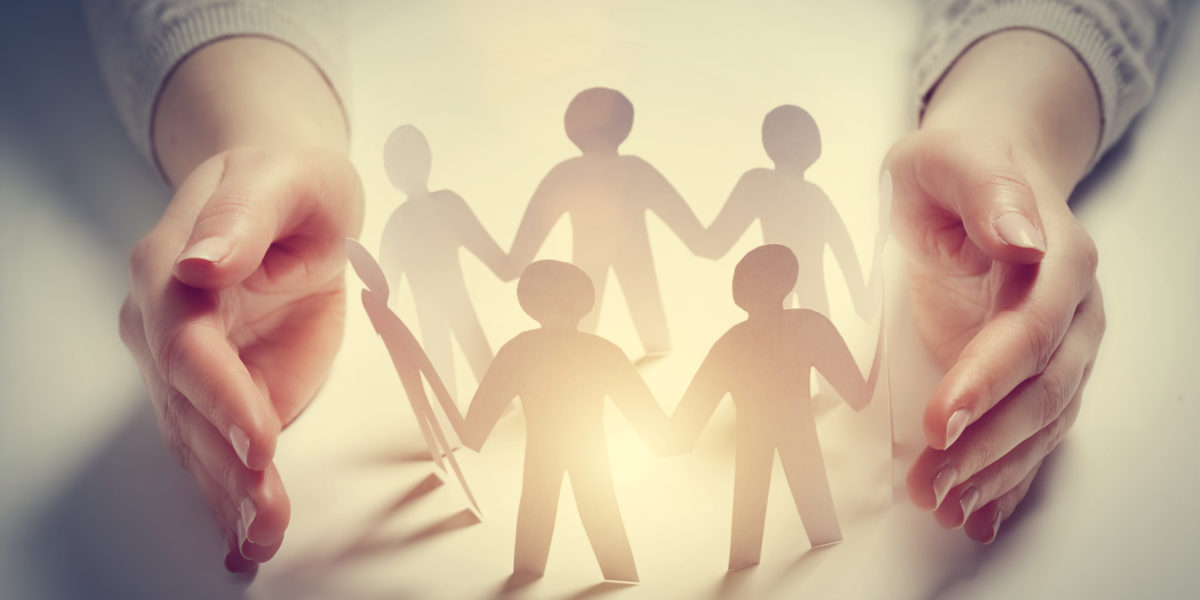 a paper ring cut into the shape of people shows a travel agent protecting their clients trip from unforeseen circumstances.